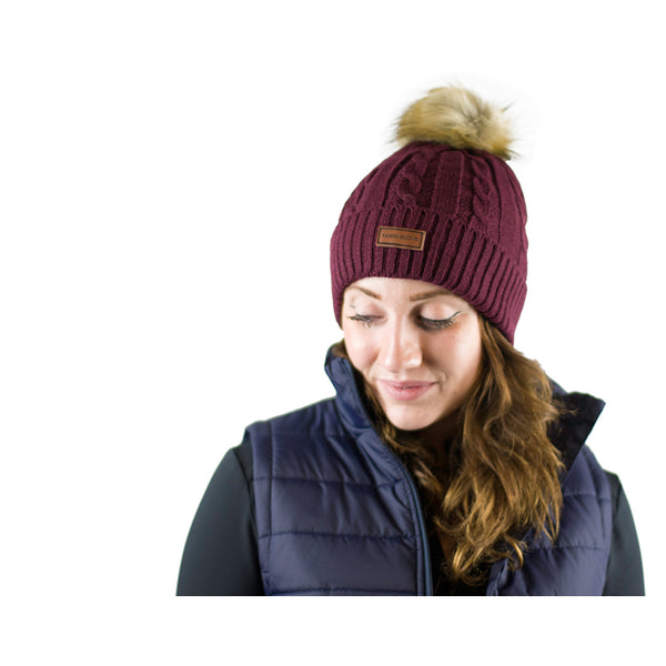 Lady wearing Cameo Cable Knit Bobble Hat in plum