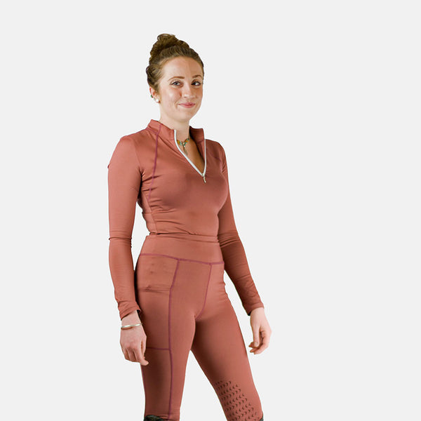 Model wearing Cameo Core Collection Baselayer in terracotta with matching riding tights