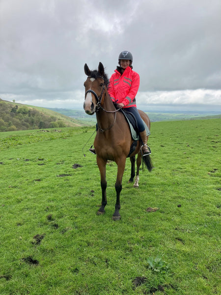 Sponsored rider Ellie wearing her HyVIZ waterproof jacket in pink.