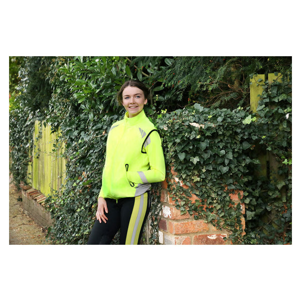 Lady wearing Reflector Gilet by Hy Equestrian in Yellow
