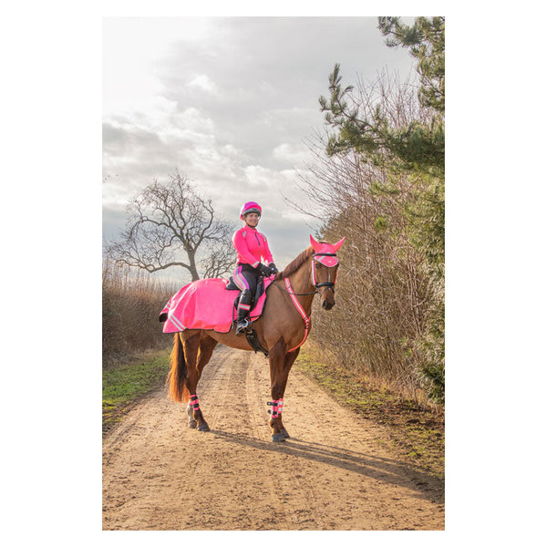 Rider wearing Reflector Base Layer by Hy Equestrian in pink